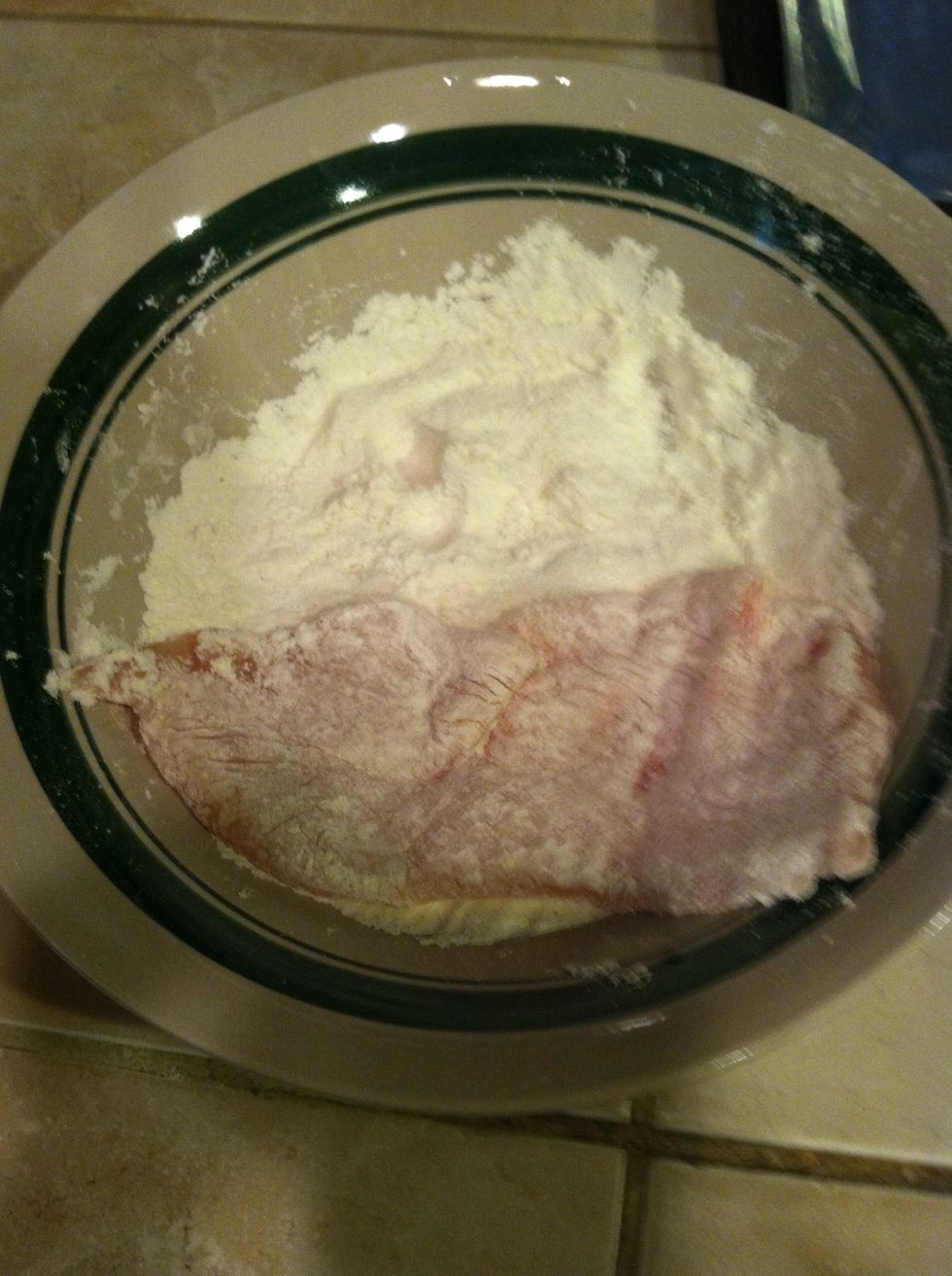 Grab a piece of your thinned breast and put in flour mixture, coat on both sides