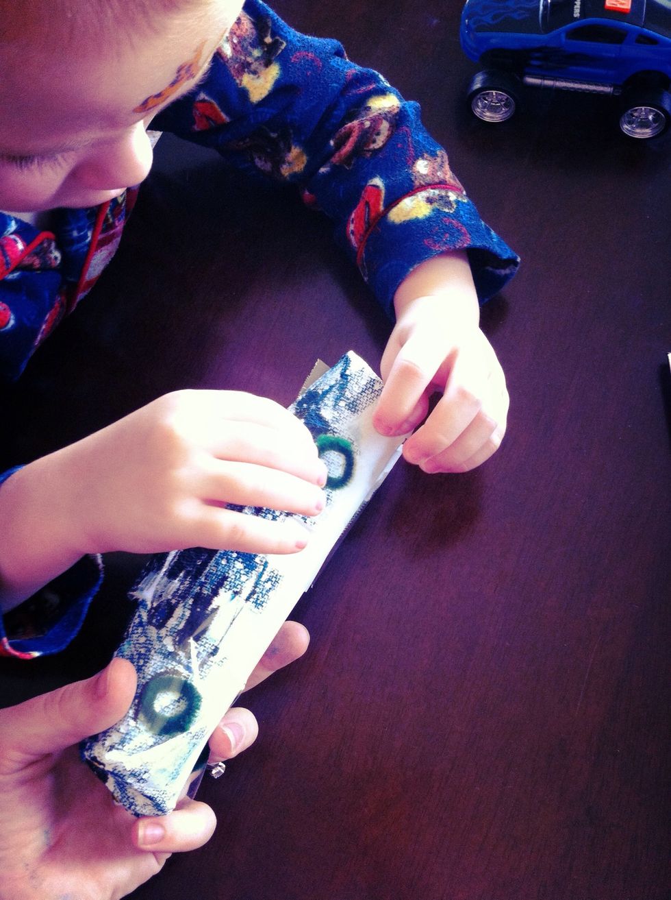 Grab a pipe cleaner. Cut it into 4 pieces. Roll each piece into a circle. Tape these pipe cleaner "wheels" onto your awesome car!