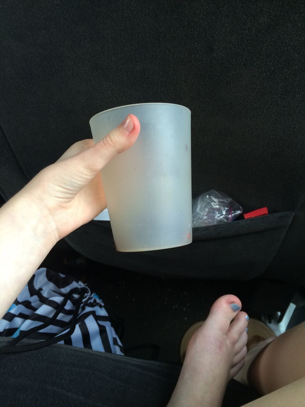 Grab a plastic cup big enough to hold your drink. (Please ignore the messy car and random foot)