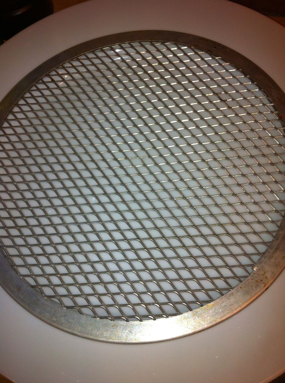 Grab a plate to put your cooked crepes on. I put a mesh pizza base over a plate to prevent the bottom crepe from sweating but this isn't critical.