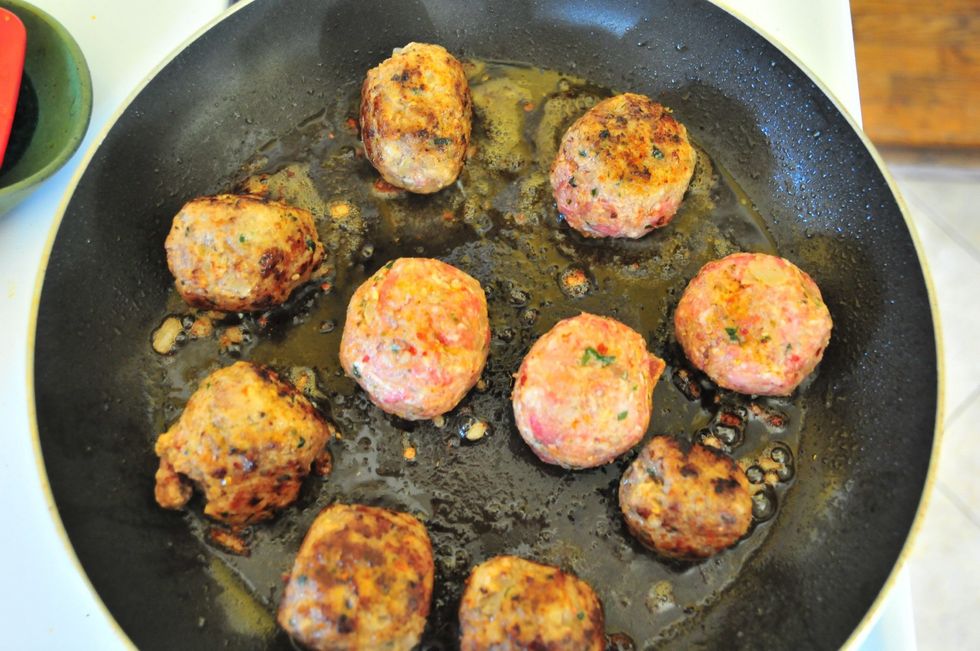 Grab a saut\u00e9 pan and add a couple tablespoons olive oil. Get the pot hot over medium high heat.  Add the meatballs and brown on all sides.  Don't burn them, be gentle and give them a nice browning.