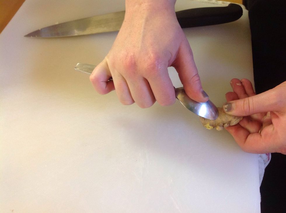 Grab a small pice of ginger. And use. The spoon technique to peel it.