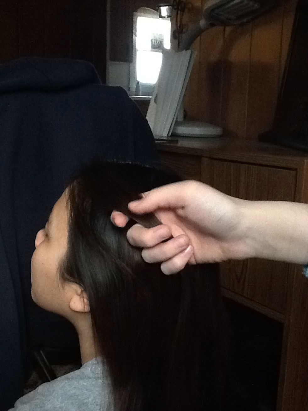 Grab a small section on the top front of the hair.