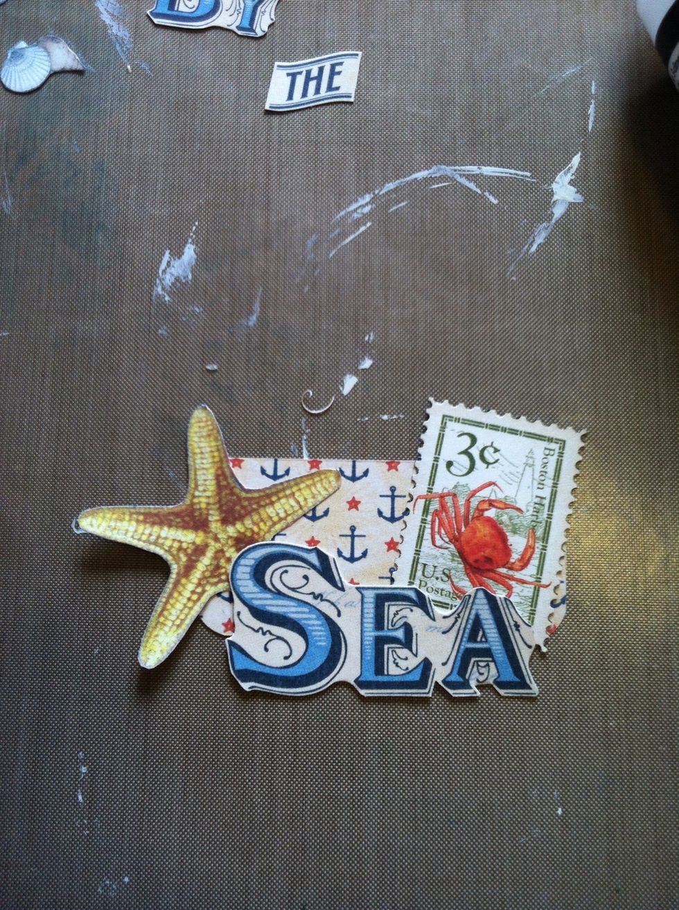 Grab all the bits you fussy cut earlier. I glued down the postage stamp, the starfish from the 8x8 stack and the SEA from the 12x12 stack. I also glued on the BY from the 8x8 and the THE from 12x12