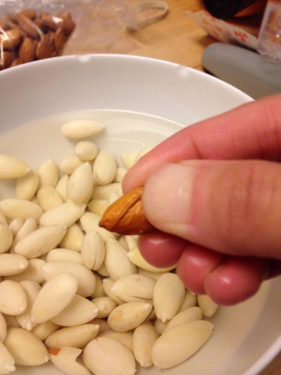 Grab firmly, twist and push the skin from the nut.
