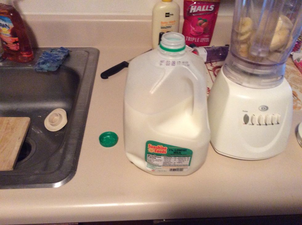 Grab milk and take the cap off