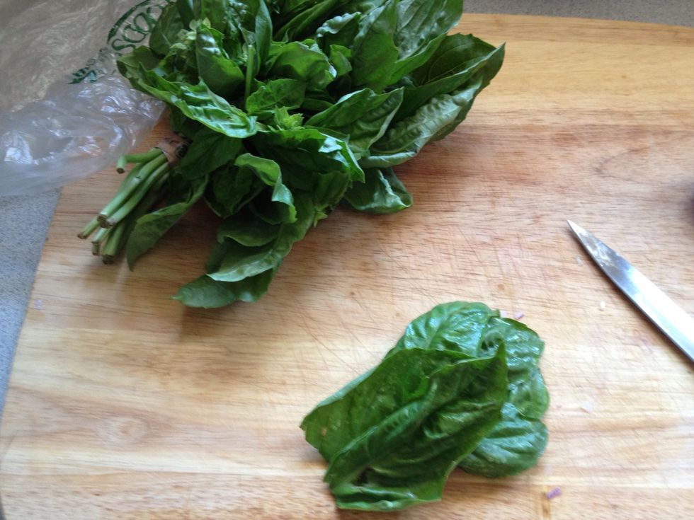 Grab some fresh basil leaves, bunch up and cut into strips.