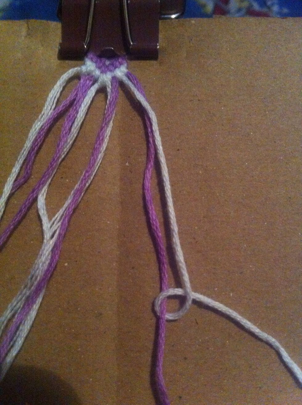 Grab the 7th and last string, but this time make a 4ward knot with the 7th str. (White) over the last str. (Purple).