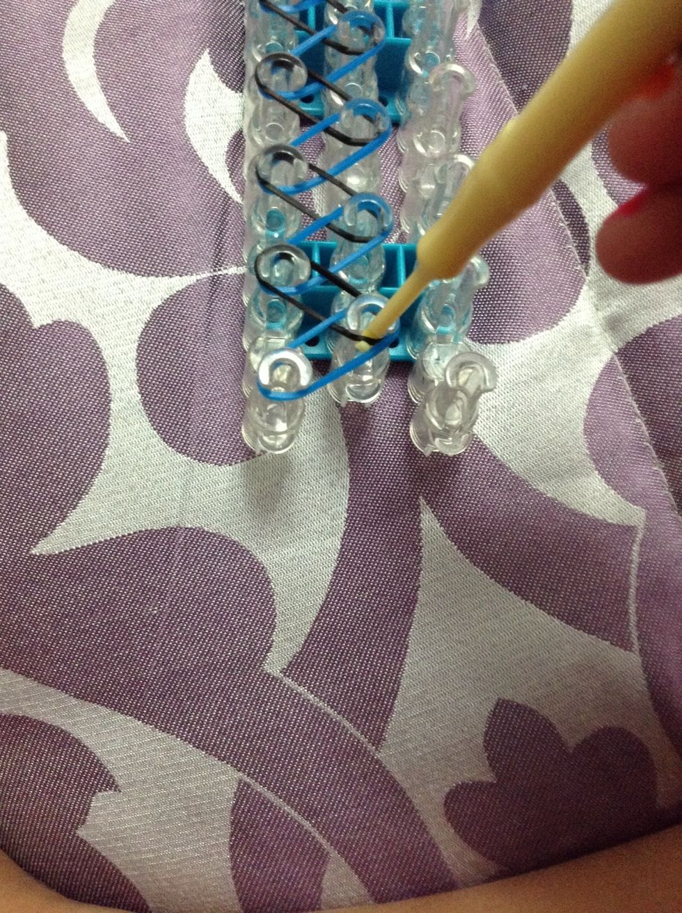 Grab the (black) elastic with the hook