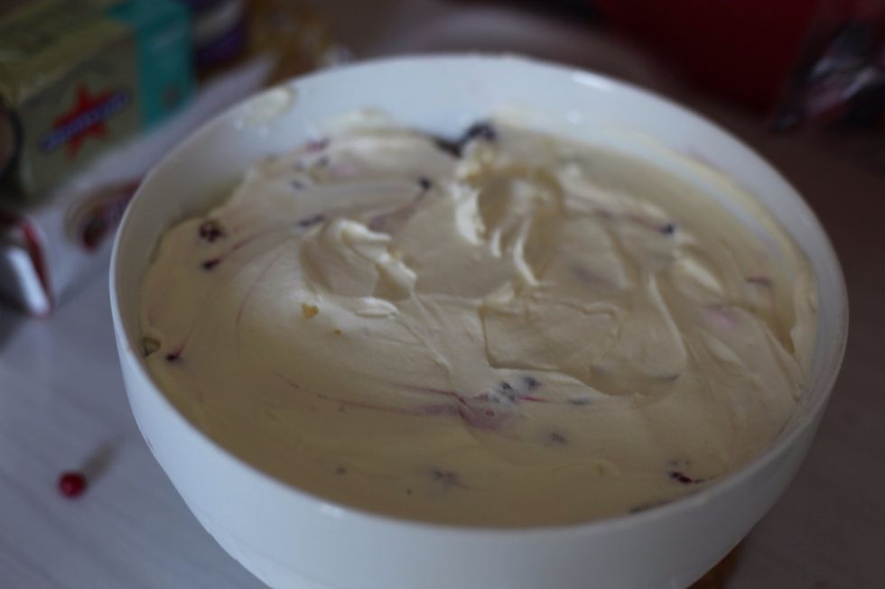 Grab the cream out of the fridge and cover the berries completely.