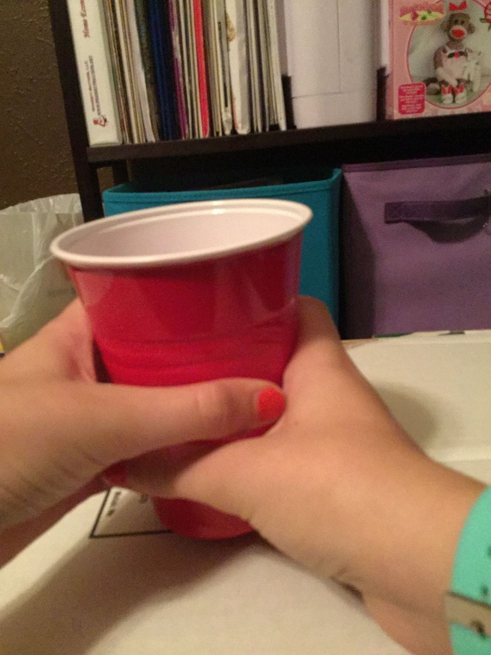 Grab the cup with your left hand and transfer it from your right hand to your left.