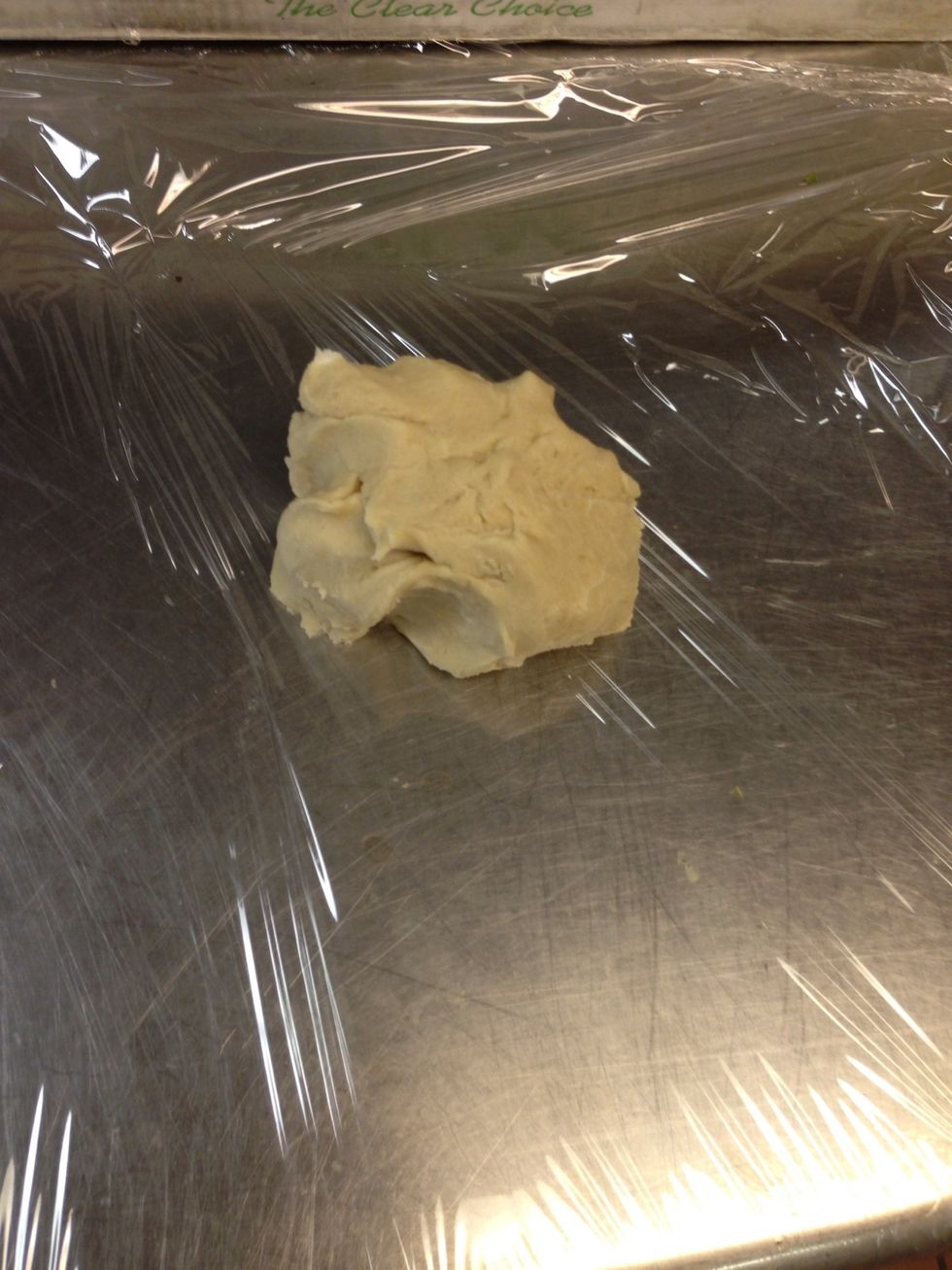 Grab the dough and place it in a film of plastic wrap