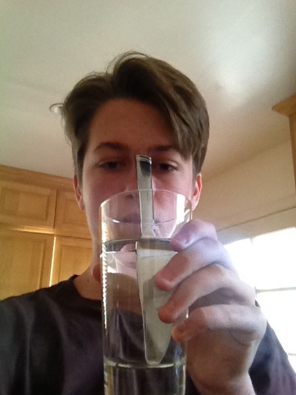 Grab the glass and place the handle of the knife on the bridge of your nose