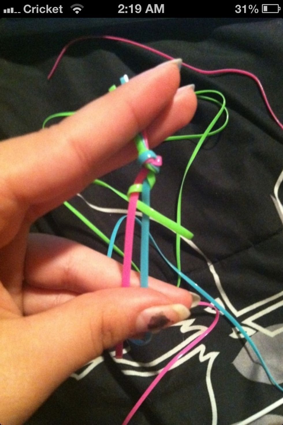 Grab the green lace and wrap it over the blue.