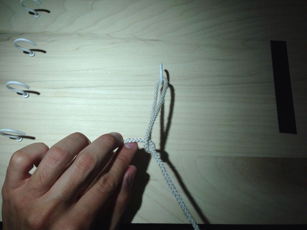 Grab the loop between your index and middle finger and pull it through the loop.