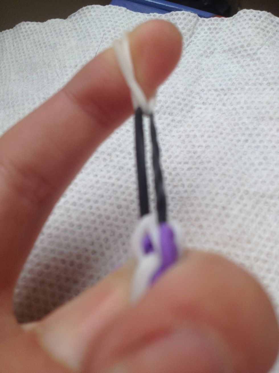 Grab the loose ends of the "white" band. It will create this...