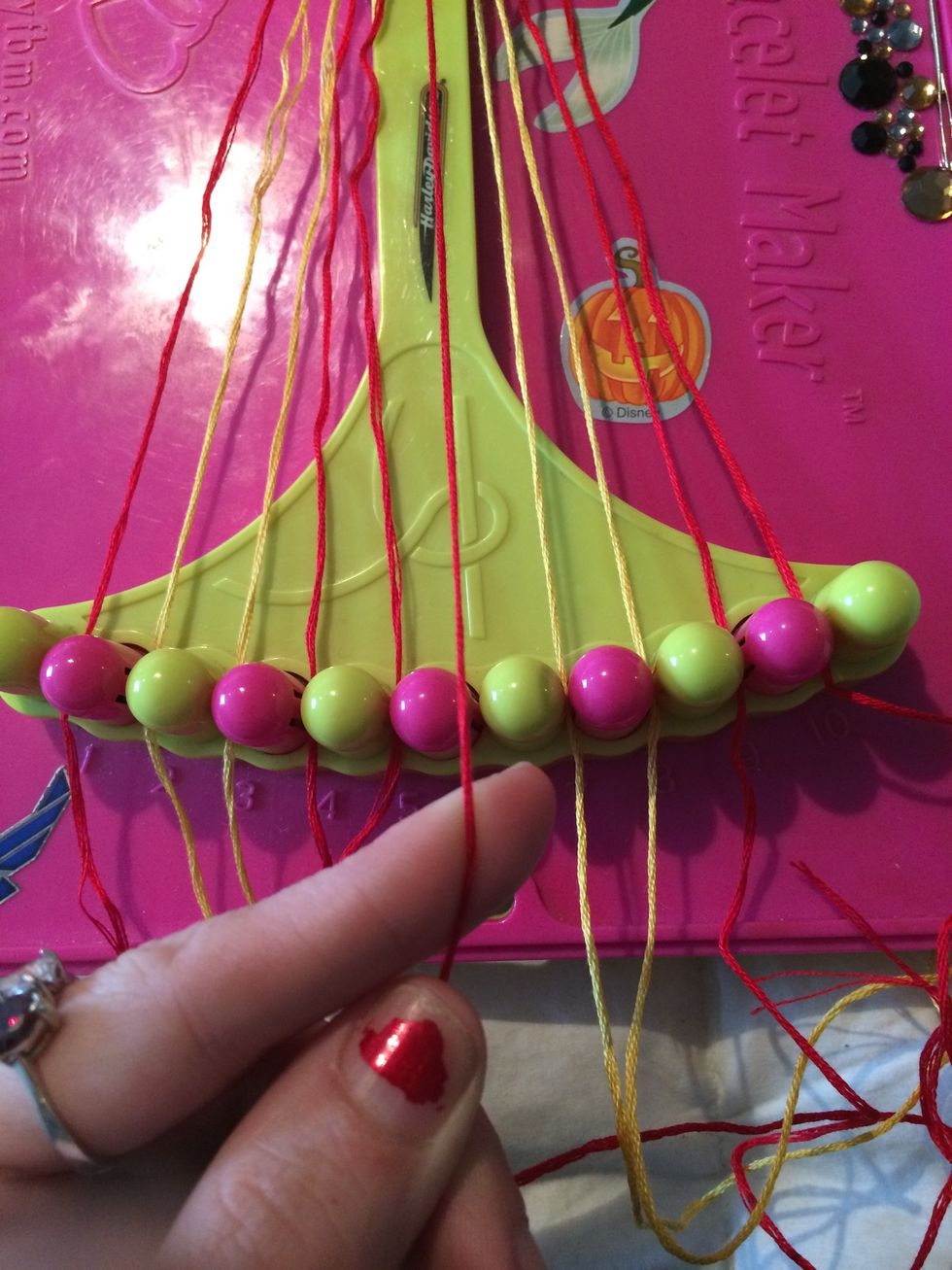 Grab the next red string and make your way across the other strings.