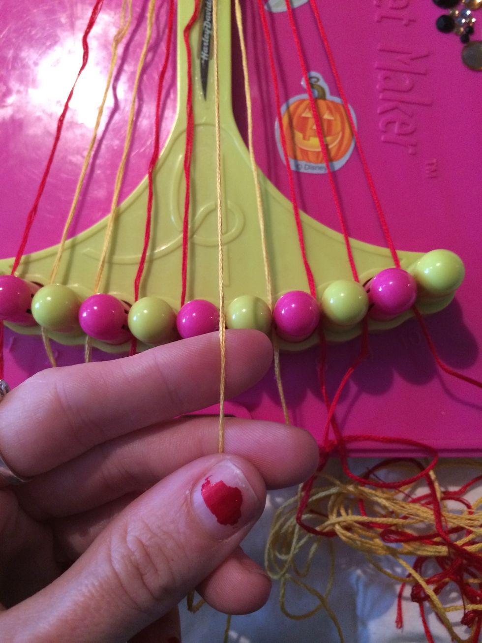 Grab the next string which will be gold if you are following my color scheme. Knot across the four other strings.