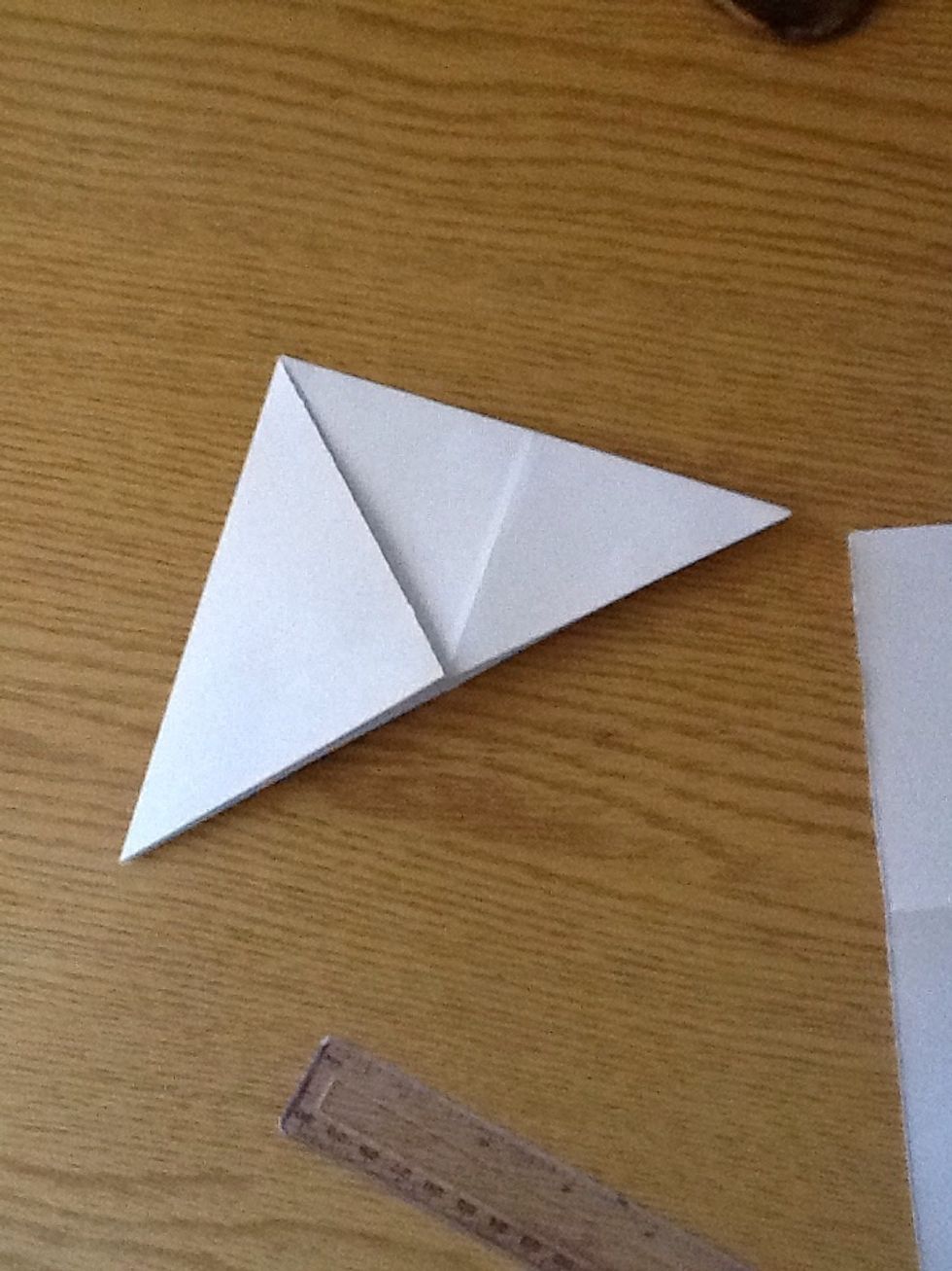 Grab the other corner and fold it.. And this is the 2nd triangle..