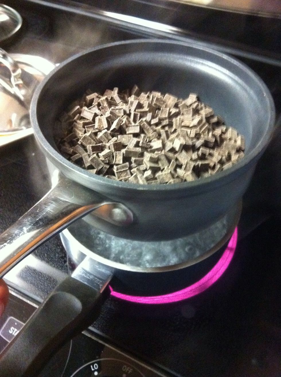 Grab the pot of chocolate nibs and put it on top of the boiling pot of water. make sure that all of the nibs melt completely. Stir occasionally.