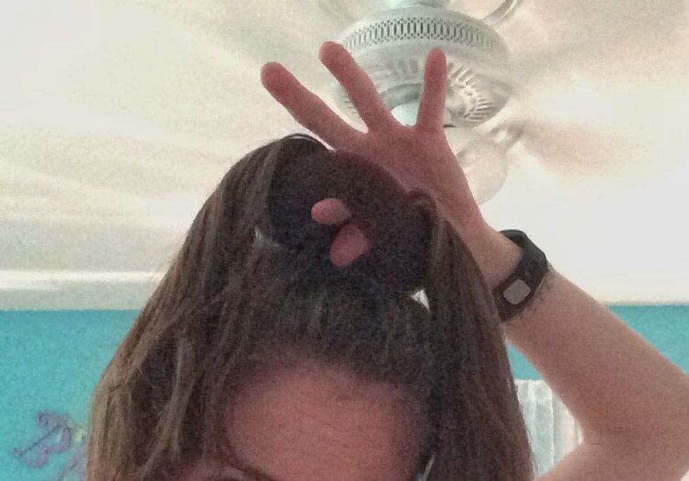 Grab the right part of the pony tail. Put your fingers in between the bun maker and pull your hair through it. Bobby pin your hair each time you pull your hair through the bun maker.