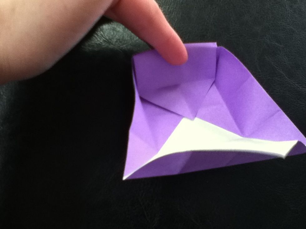 Grab the section over the corners you just folded and fold it over. The will create the side of the box.