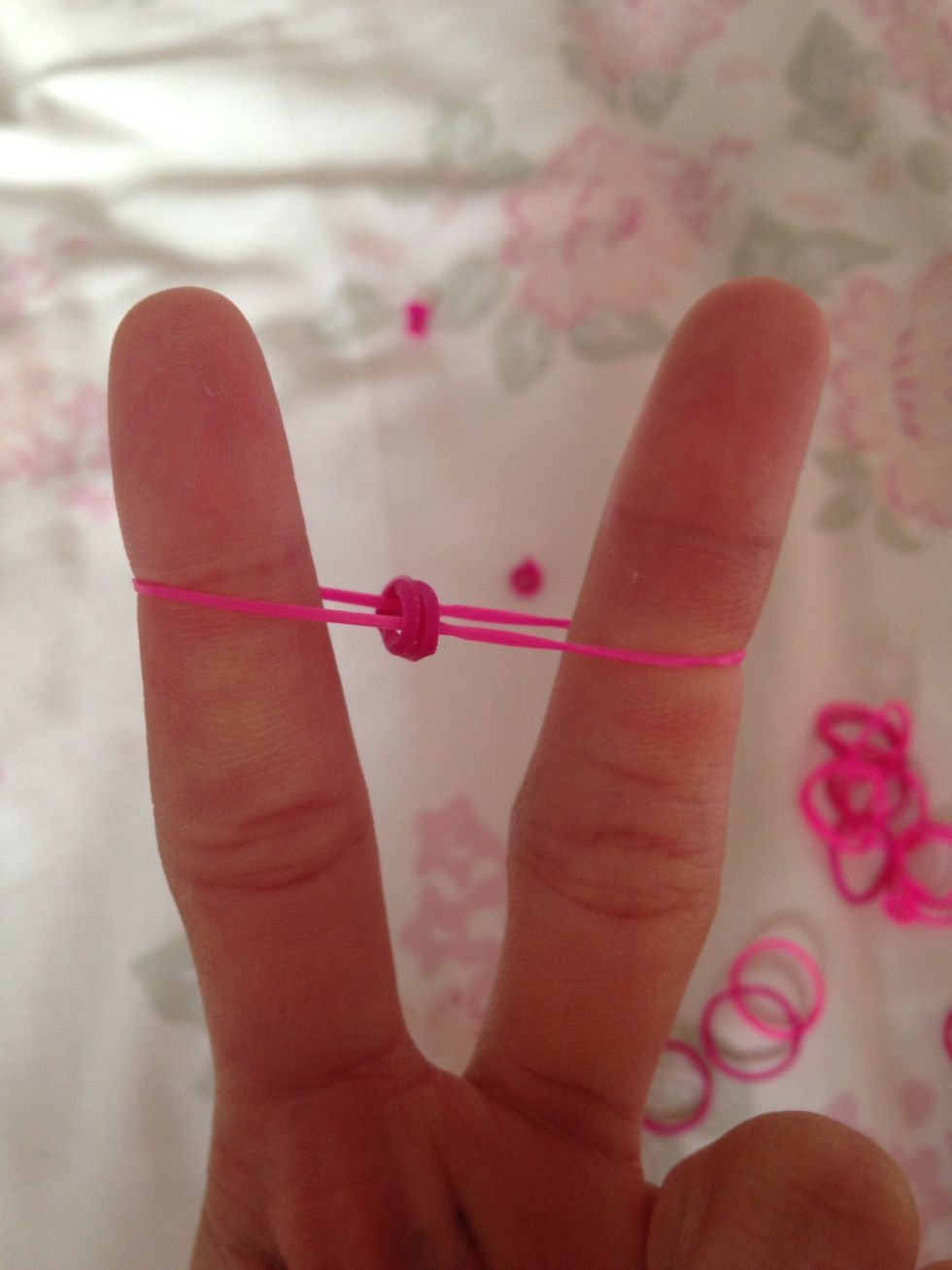 Grab the sides of the bottom band and pull them up and over your fingers. Do on both sides.