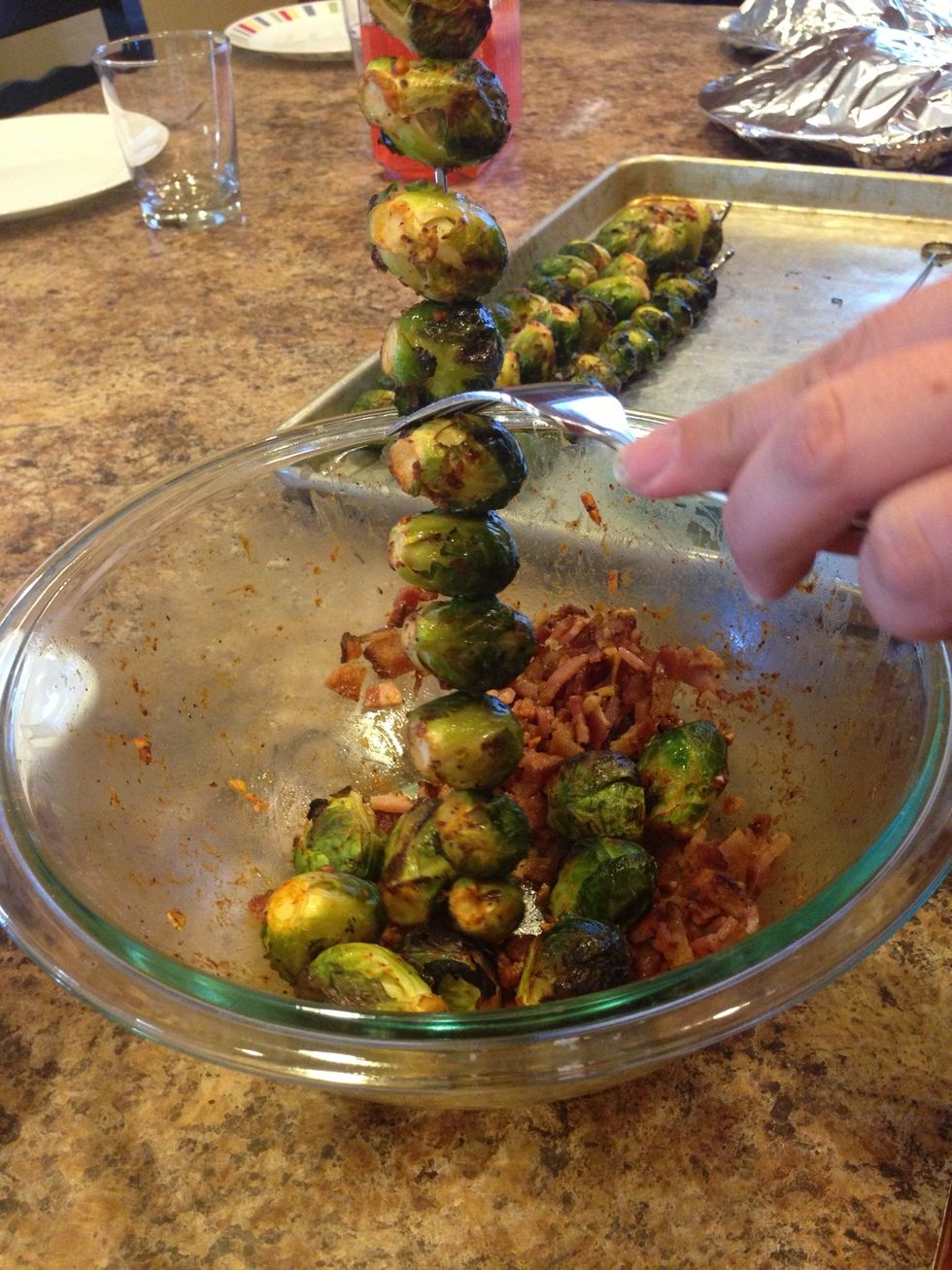 Grab the skewer at the top, use a hot pad if its still to hot to handle, and slide a fork down the skewer every 3 or 4 Brussels sprouts until they are all in the bowl.