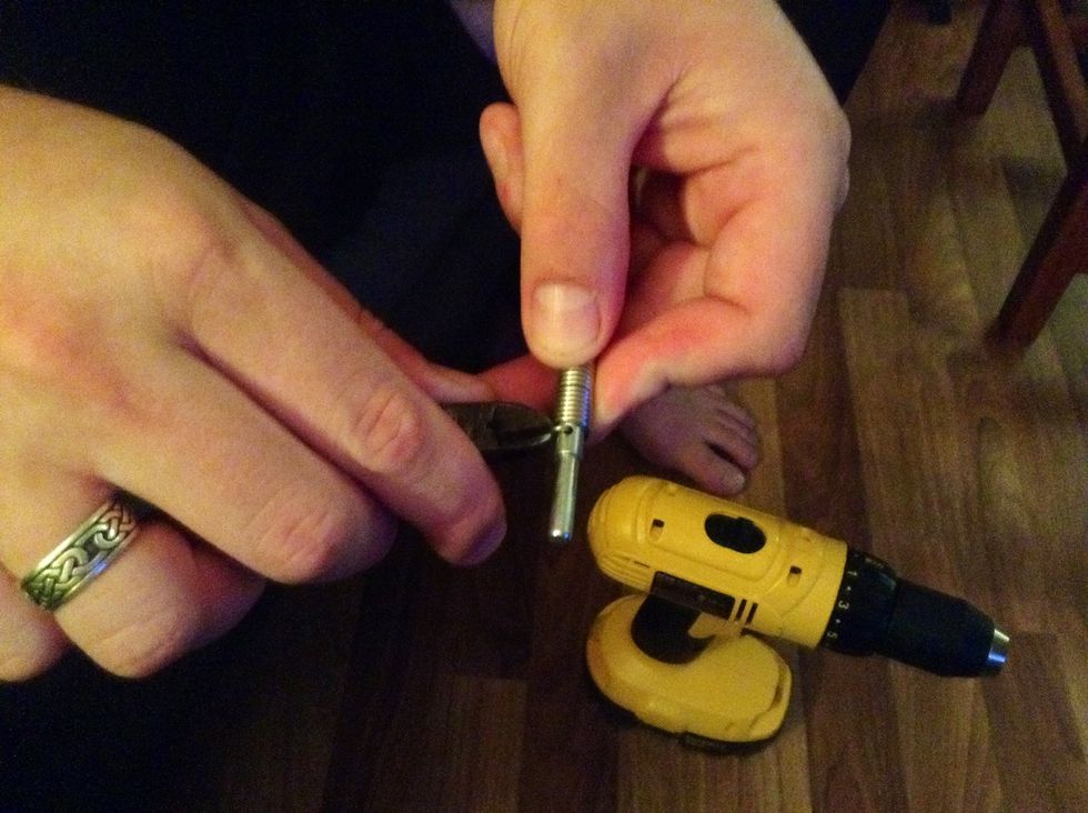 Grab the wire cutters and cut the wire where it was first introduced to the hole to release it from the rod.