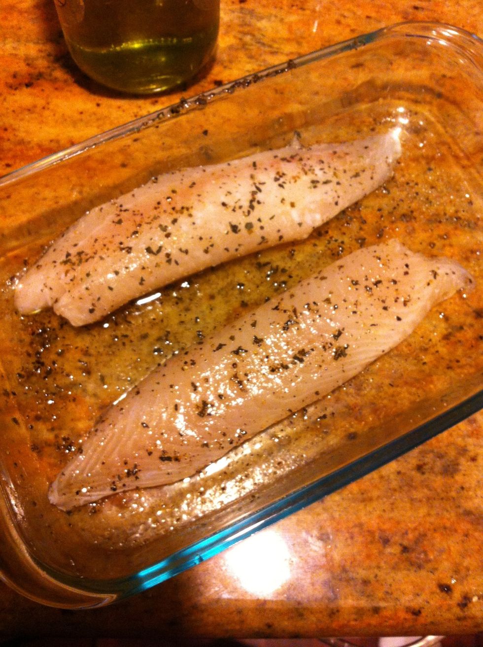 Grab tilapia filets. Season liberally with oliv oil, then salt, pepper, and dried basil leaves (oregano works, too).