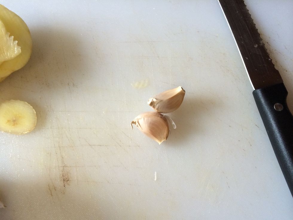 Grab two cloves of garlic, de-skin and chop.