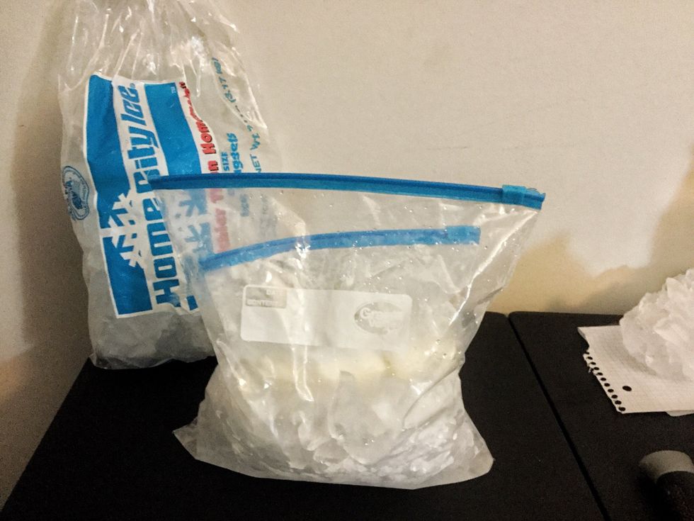 Grab you bigger plastic slider zipper bag. Pour your 1 cup of salt and a lot ice into the bag. Place the small closed bag with the mixture inside the bigger bag.