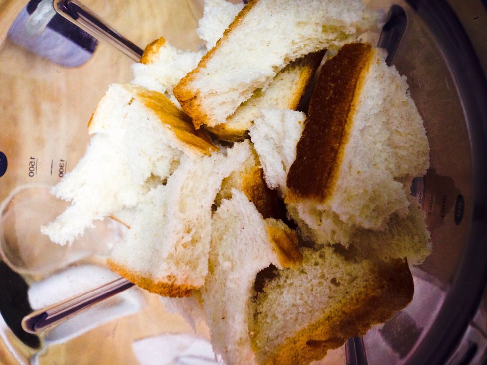 Grab your 7 slices of toast bread, tear it apart, and put in the mixture to get a bread crumble.