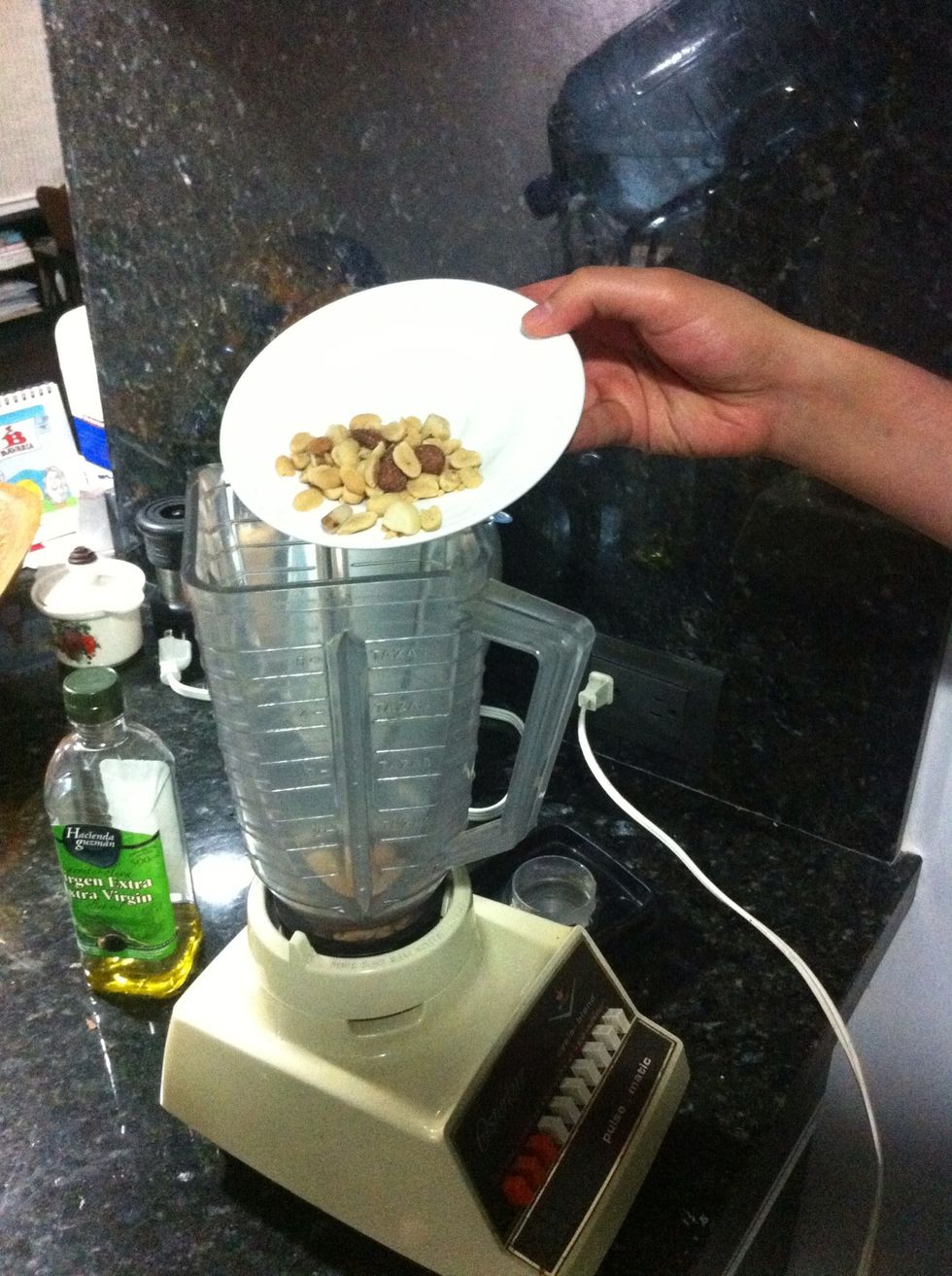 Grab your blender or food processor. Add the pine nuts to the blender (I used mixed nuts in this case).