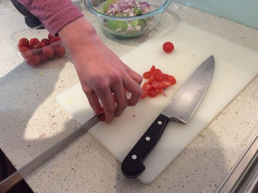 Grab your cherry tomatoes (you only need 6-8) and cut them into quarters and then pop them into the bowl.