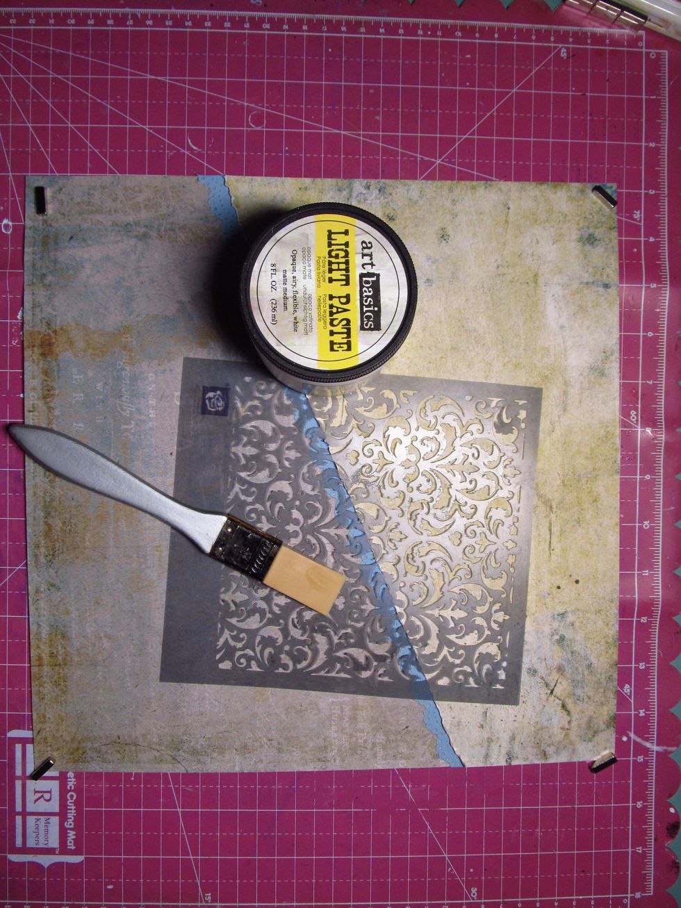 Grab your favorite stencil and some modeling paste. We are going to do some light random stenciling to the background.