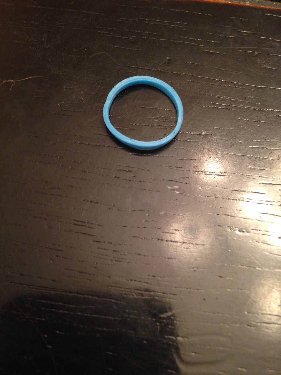 Grab your first rubber band. I am using glow in the dark bands because it looks cooler in the dark. But you don't have to use glow in the dark!!!
