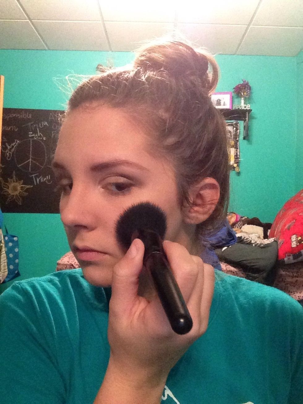 Grab your fluffy brush for setting powder and dab a fair amount on it. Brush a light layer all over your skin to set all of your makeup, don't brush over eyeshadow.