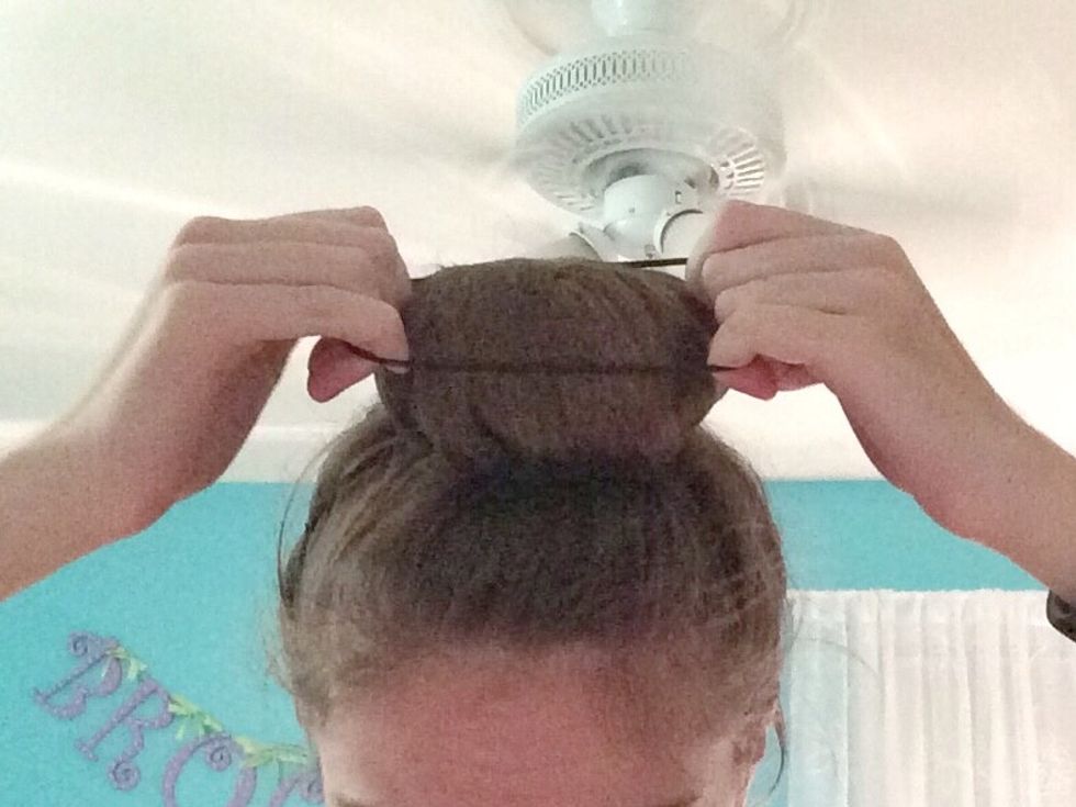 Grab your last pony tail, and pull it over the bun.