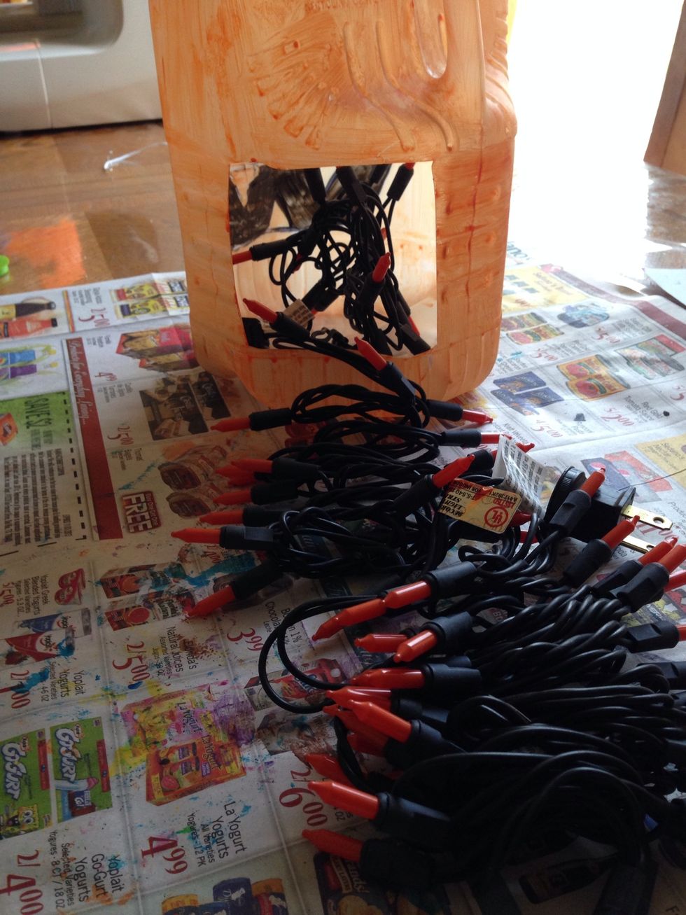 Grab your lights and put them in through the hole in the back.