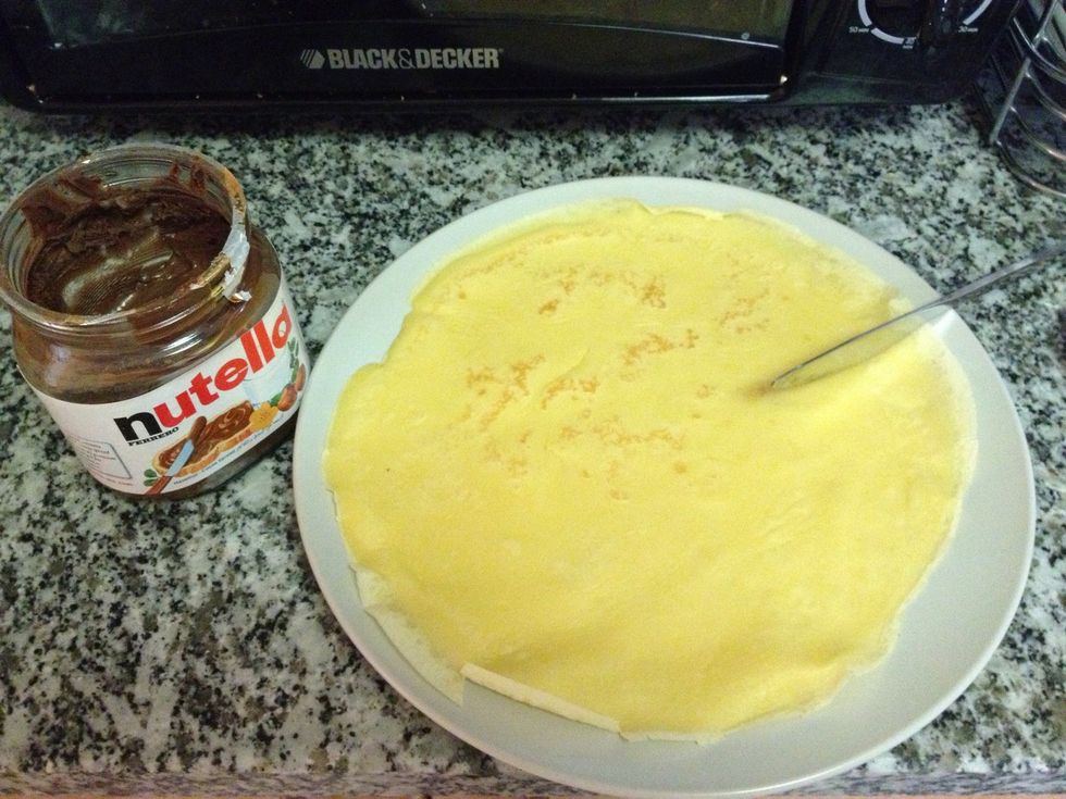 Grab your Nutella and spread on your crepe.