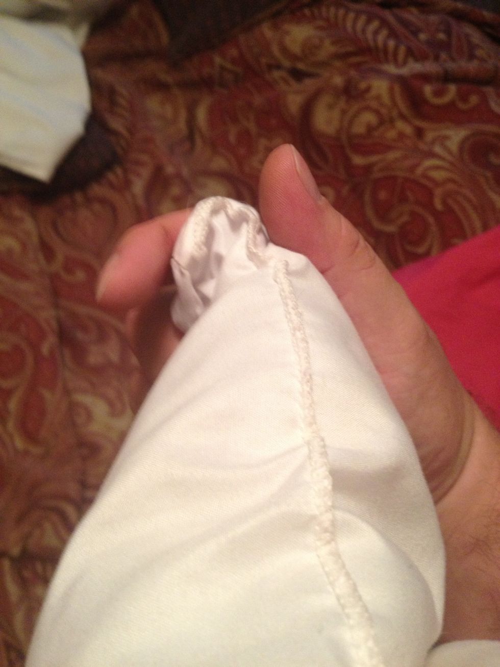 Grab your pillow by one corner.