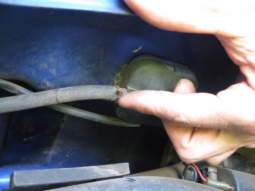 Grab your pliers and slide this clamp down the hose then remove the hose.