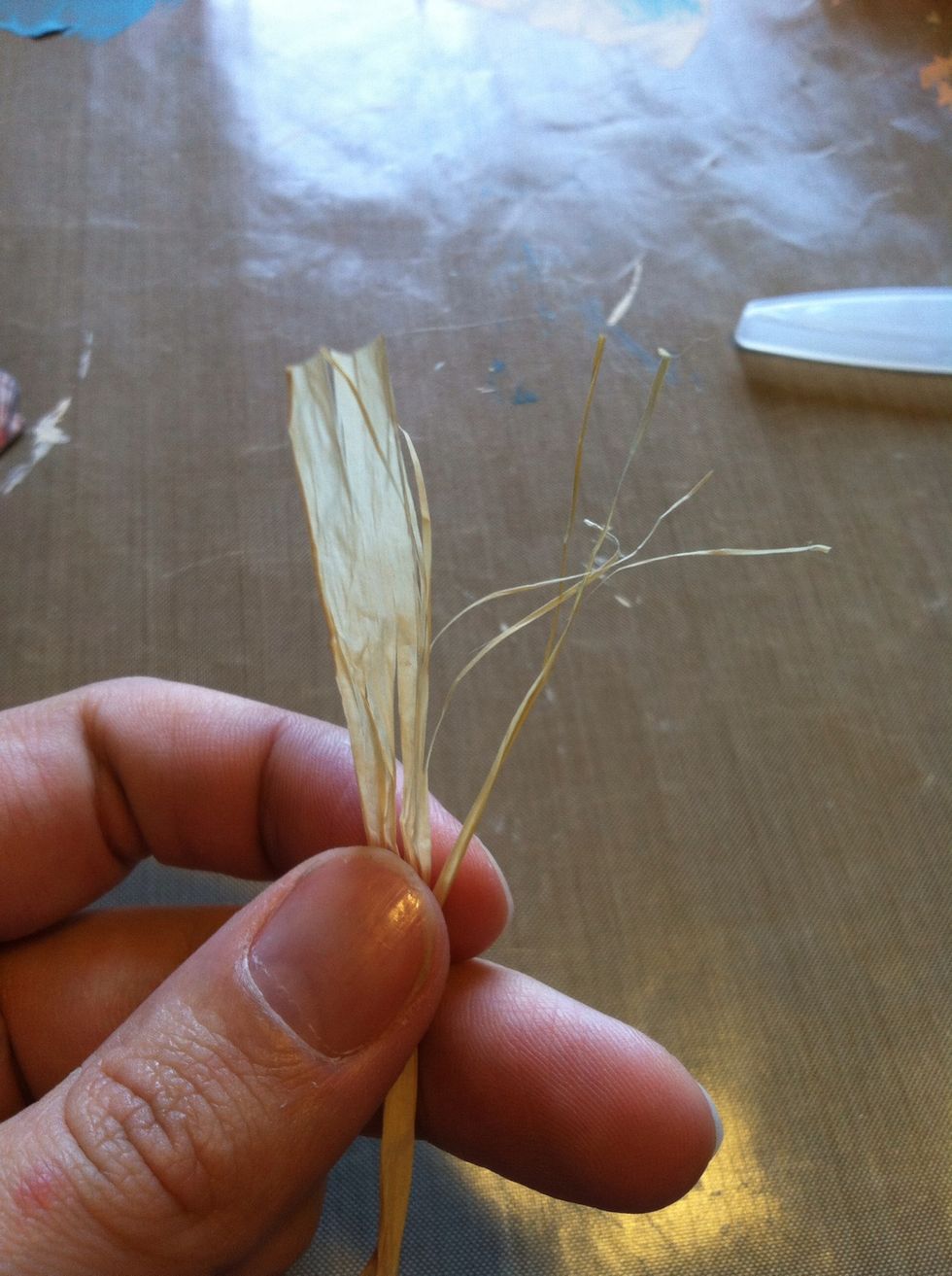 Grab your raffia. I used about a foot and a half. I shredded the end to look like beach grass, but left the other end together. Each piece is about 1.5"-2" long.