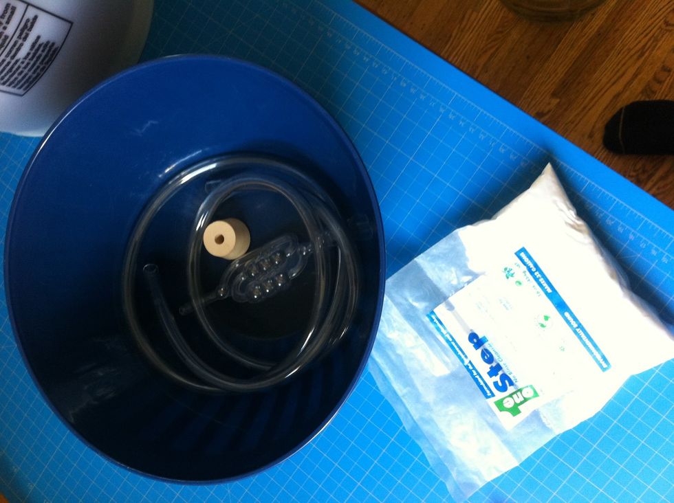 grab your rubber stopper, siphon tube, and airlock. put a teaspoon or so of sanitization solution into some warm water and drown your supplies to death.