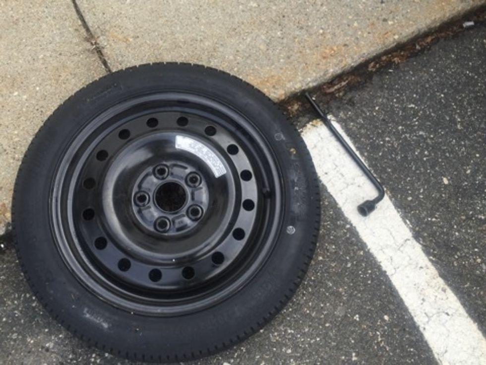 Grab your spare tire and bring it over to the vehicle. Line up the holes with the screws and place tire on hub.