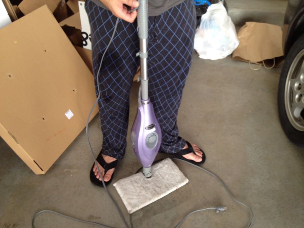 Grab your steam mop, or steamer, and fill with water. You will use the steam to help loosen the glue so that you have no sticky residue on the glass. It will also help pull the tint off much easier.