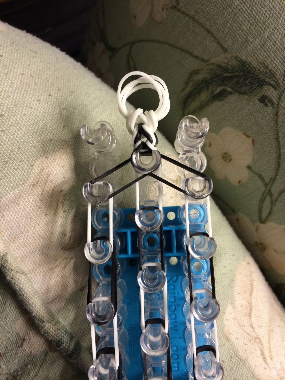 Grab your tail and put it on the very last peg in the center