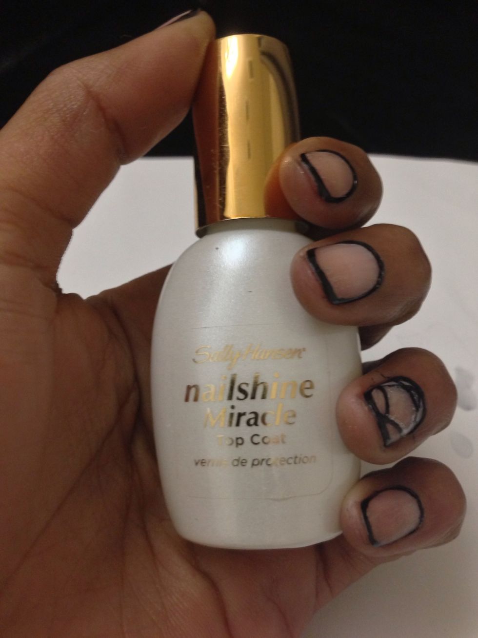 Grab your top coat and apply to all of your nails and let dry. I'm using Sally Hansen's Nail Shine Miracle.