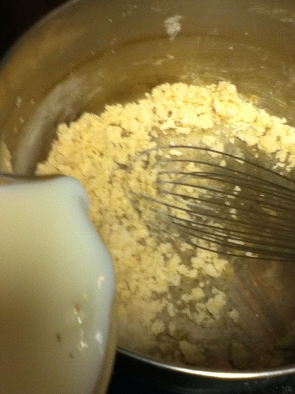 Gradually add milk. Still whisking.